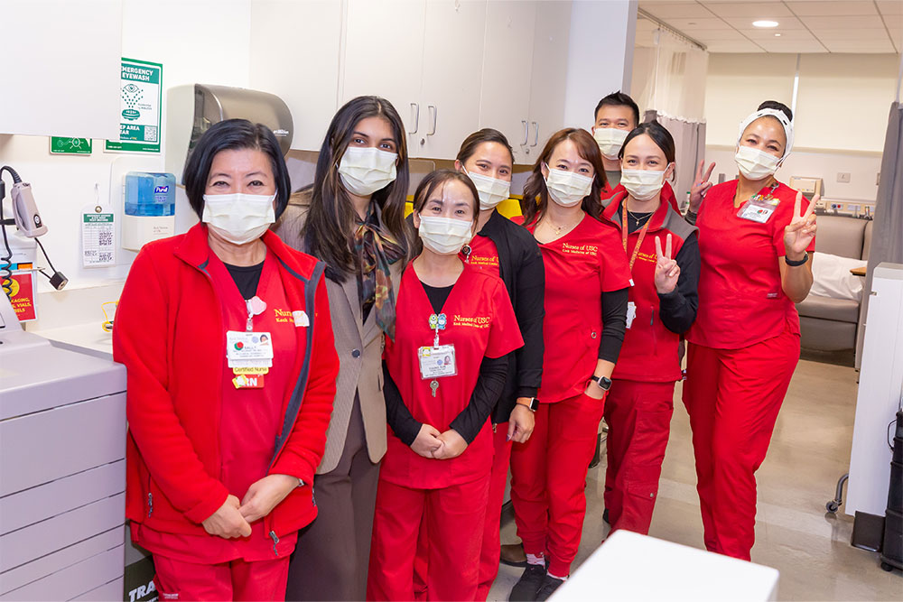 smiling nurses in red scrubs